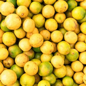A vibrant display of ripe yellow lemons, showcasing freshness at an Indian market.