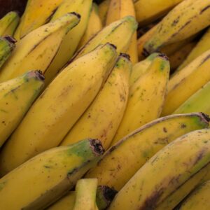 Close-up of ripe yellow plantains stacked at a market in Retiro, Antioquia, Colombia.