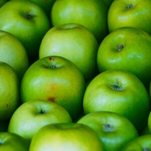 Close-up of fresh green apples on display at a market in Kodaikanal, India.