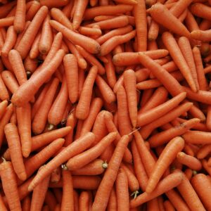 A vibrant heap of fresh organic carrots at a market in Istanbul, Turkey.