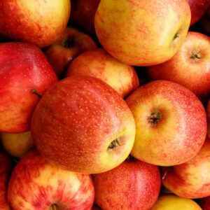 Close-up of fresh, vibrant red apples piled together, showcasing their nutritious appeal.