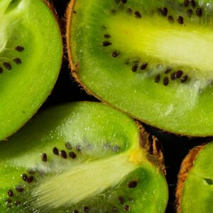 Vibrant kiwi slices showcasing texture and seeds, ideal for healthy food themes.